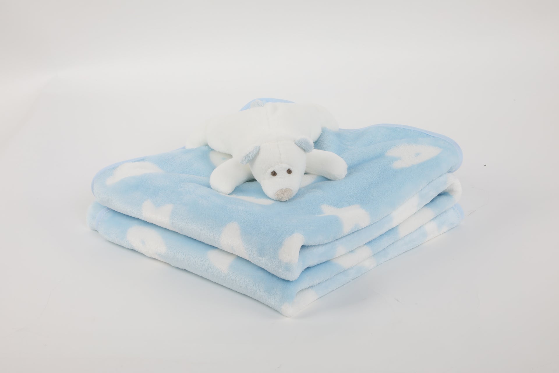 Vista de Manta de polar celeste con peluche oso polar